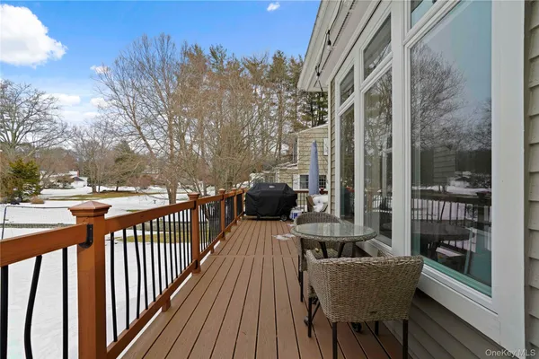 a balcony with table and chairs