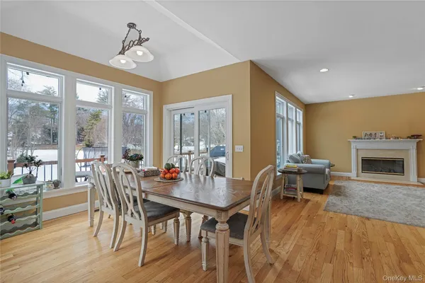 a dining room with furniture window and wooden floor