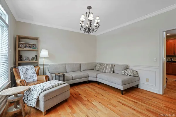 a living room with furniture and a chandelier