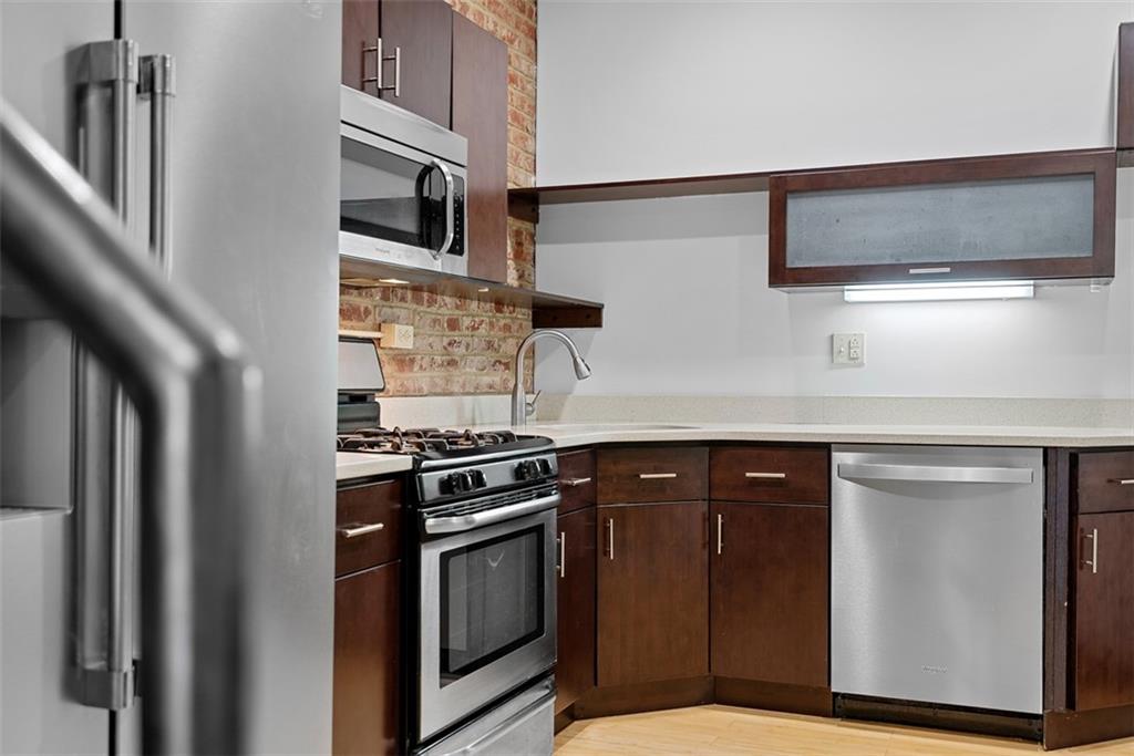 1402 James Street Pittsburgh, PA 15212 - Photo 11 of 30 a kitchen with stainless steel appliances granite countertop a stove and a microwave