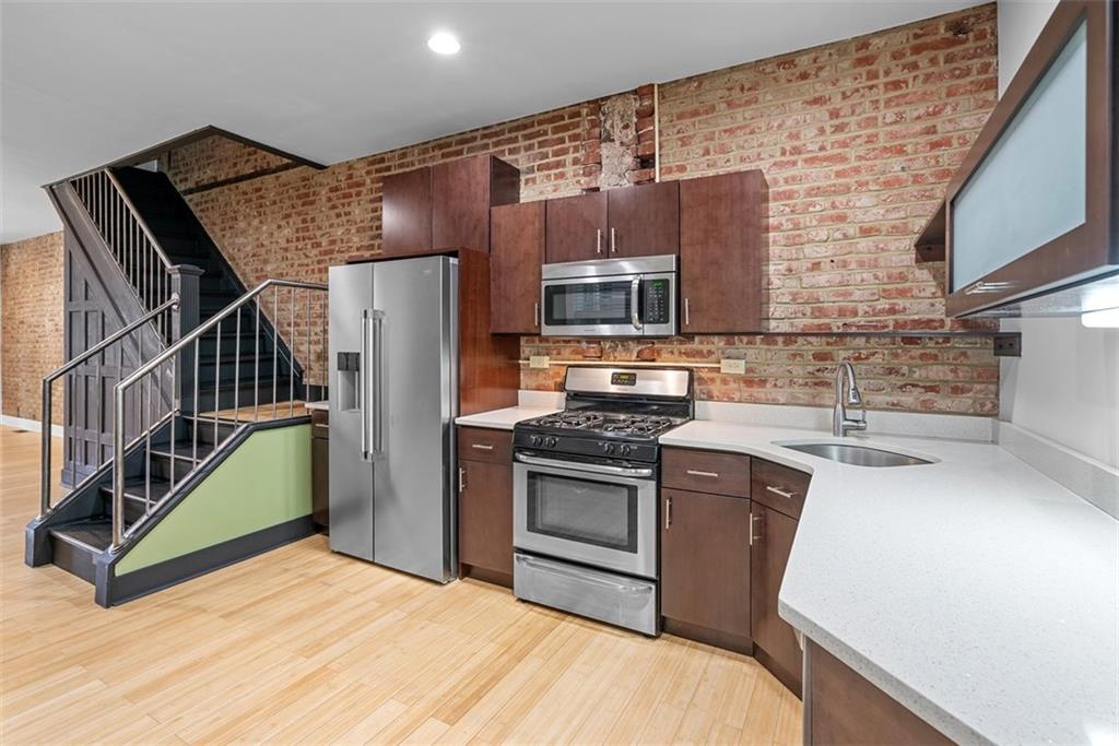 1402 James Street Pittsburgh, PA 15212 - Photo 14 of 30 a kitchen with stainless steel appliances granite countertop a stove a sink and a refrigerator