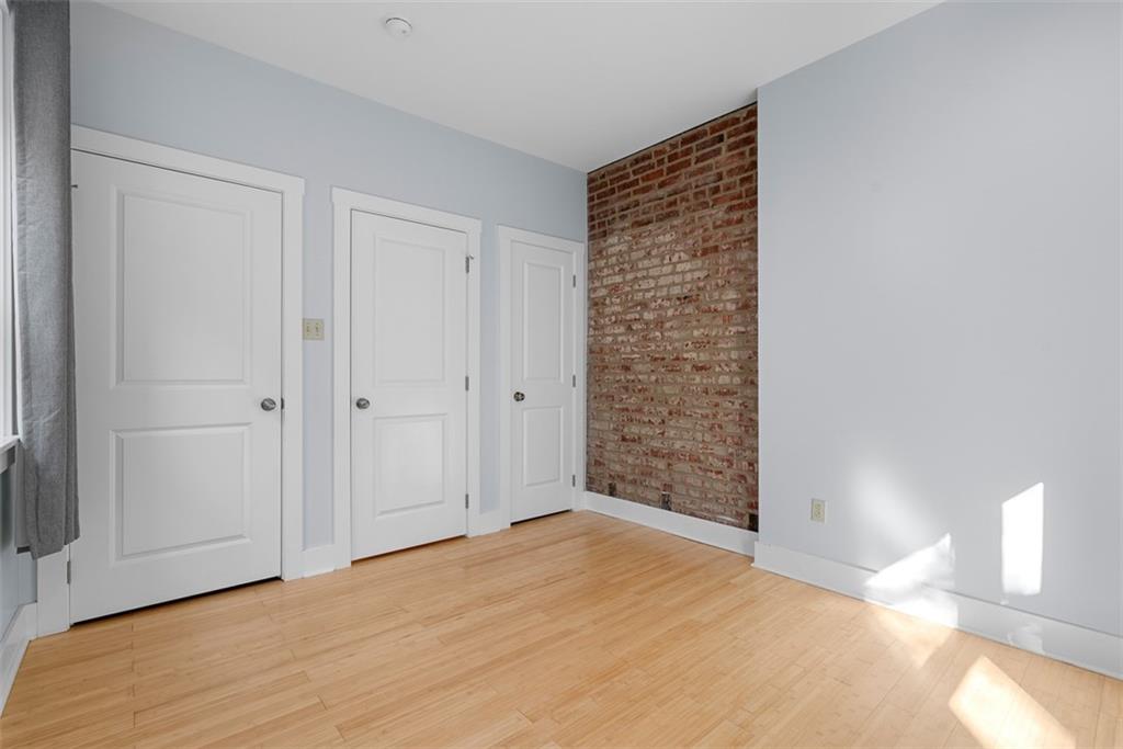 1402 James Street Pittsburgh, PA 15212 - Photo 23 of 30 a view of an empty room with wooden floor and a window
