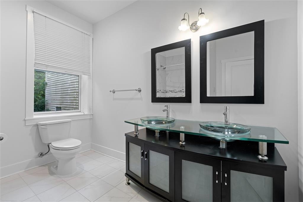 1402 James Street Pittsburgh, PA 15212 - Photo 27 of 30 a bathroom with a toilet sink and mirror
