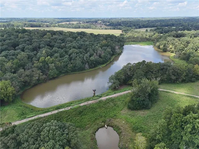 an aerial view of a houses with outdoor space and lake view