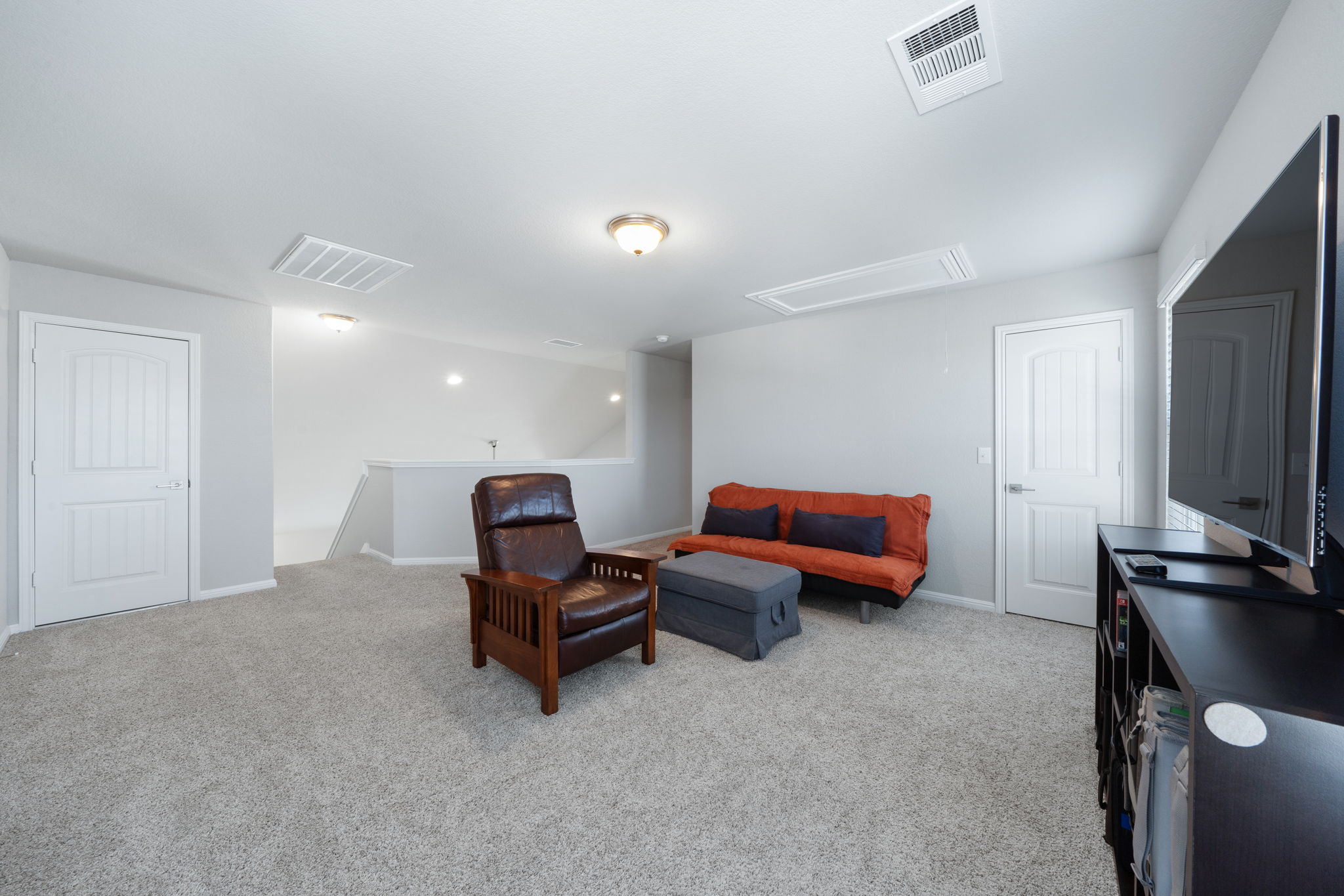 2412 Starhill Ranch Street Georgetown, TX 78628 - Photo 32 of 40 A versatile bonus room offering comfort and potential for various uses.