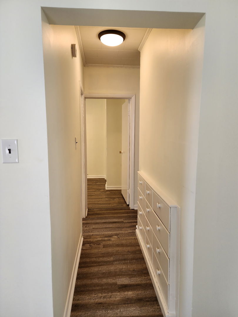 1300 West Madison Street Herrin, IL 62948 - Photo 14 of 14 a view of a hallway with wooden floor