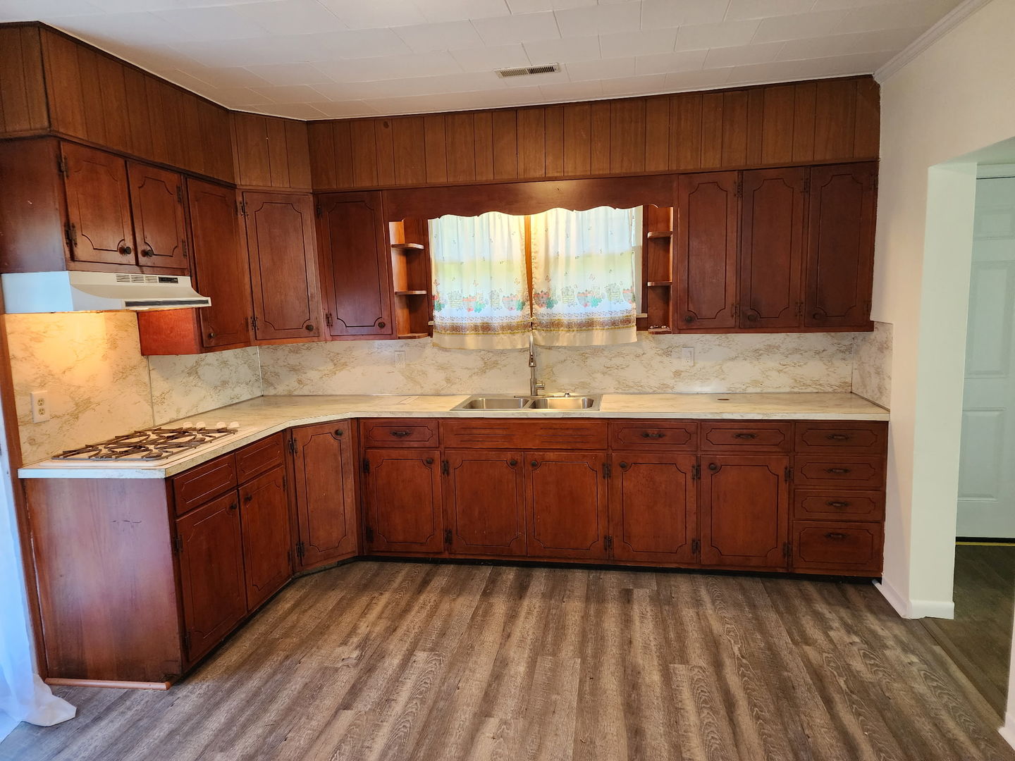 1300 West Madison Street Herrin, IL 62948 - Photo 6 of 14 a kitchen with stainless steel appliances granite countertop wooden cabinets a sink and dishwasher