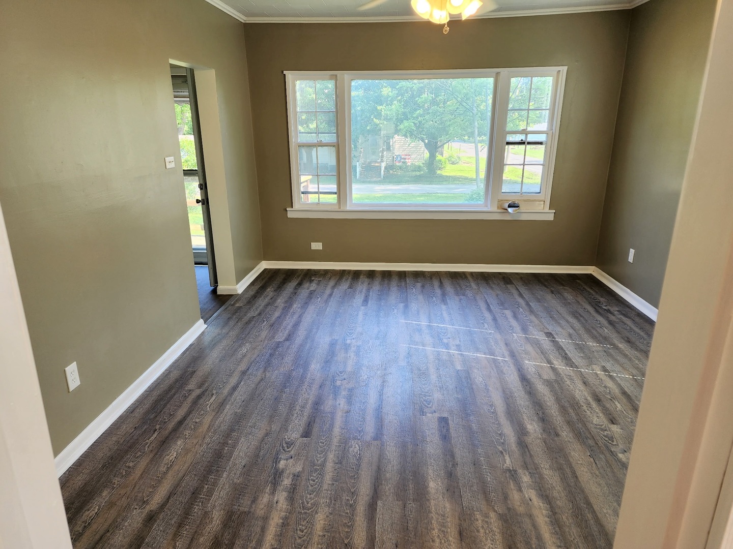 1300 West Madison Street Herrin, IL 62948 - Photo 8 of 14 an empty room with wooden floor and windows