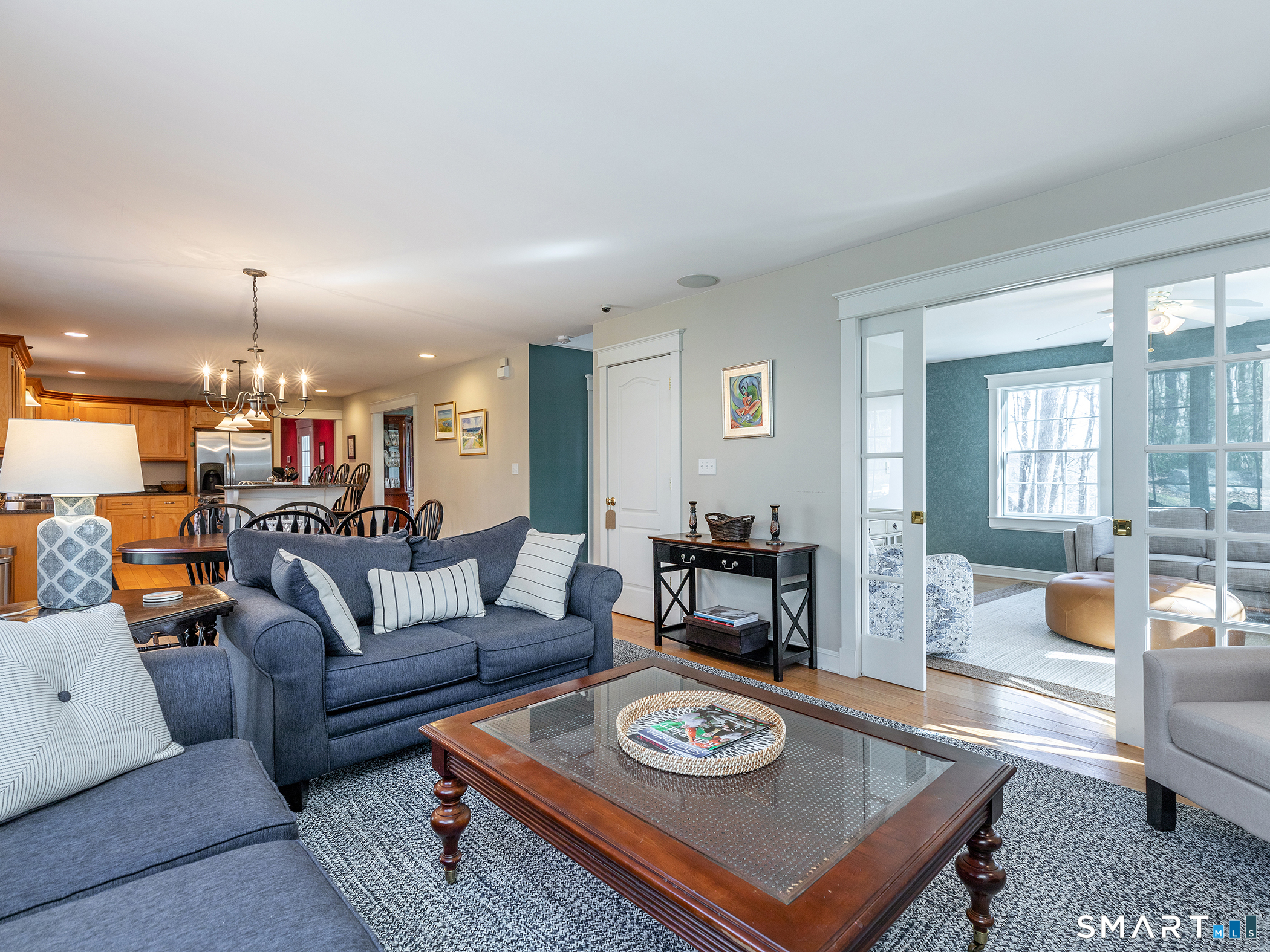 3 Weldon Court Goshen, CT 06756 - Photo 11 of 38 a living room with furniture and a dining table with wooden floor