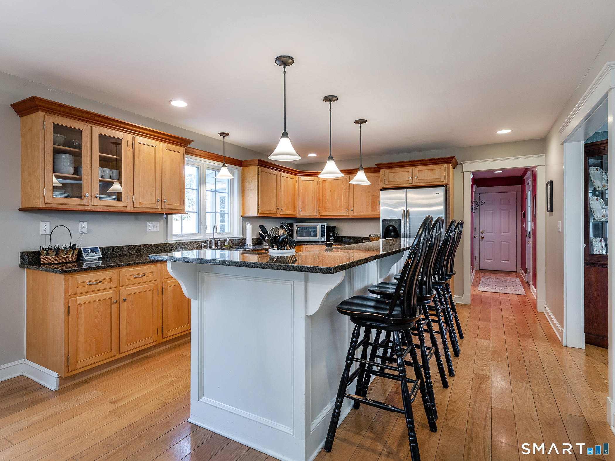3 Weldon Court Goshen, CT 06756 - Photo 12 of 38 a kitchen with stainless steel appliances kitchen island granite countertop a stove a sink a oven a dining table and chairs with wooden floor
