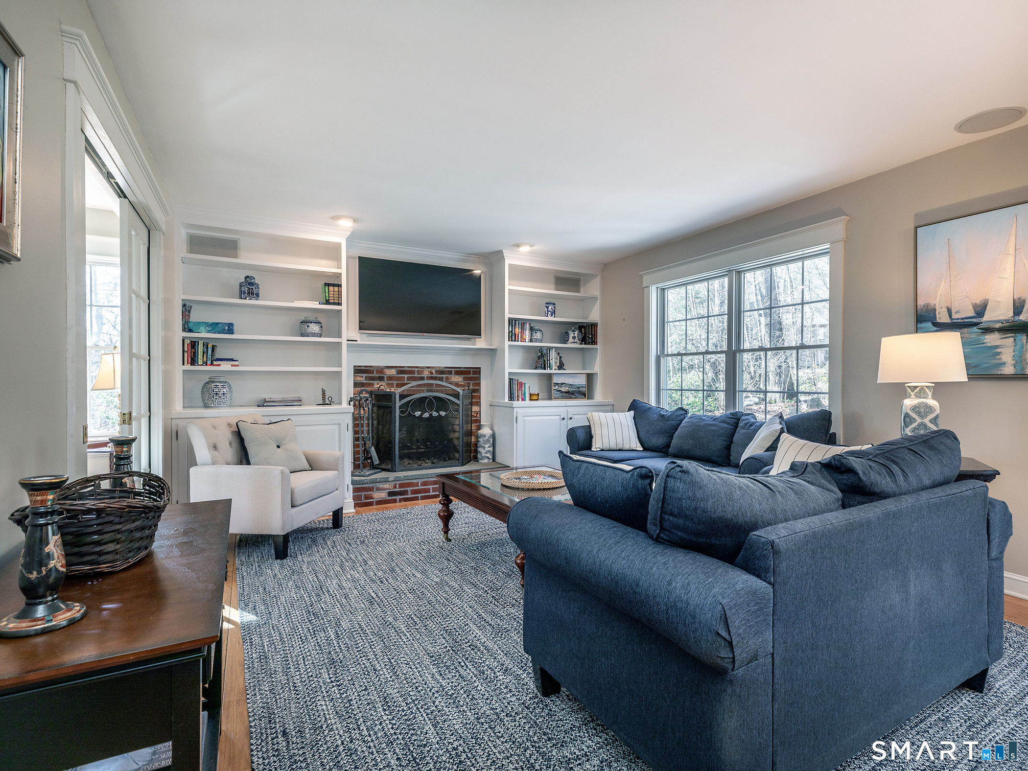 3 Weldon Court Goshen, CT 06756 - Photo 9 of 38 a living room with furniture a fireplace and a flat screen tv