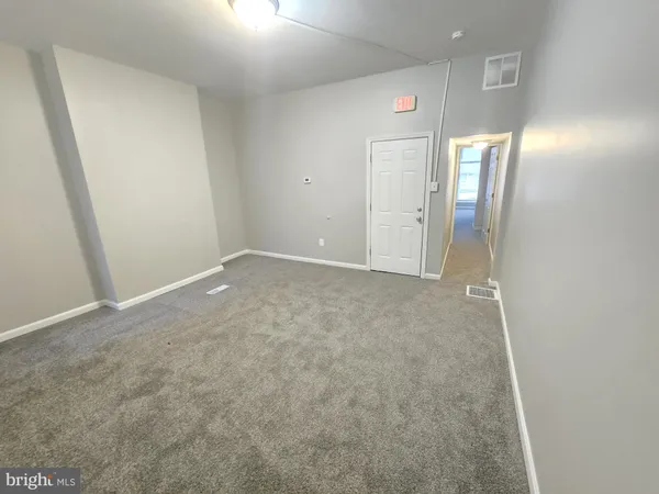 an empty room with a mirror