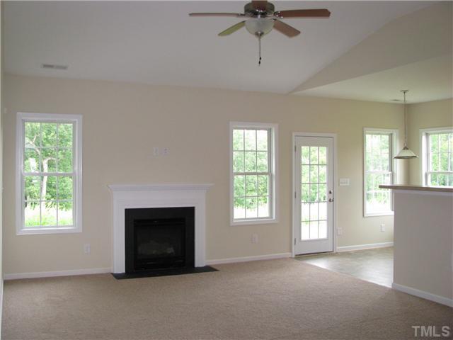 6328 Slopeside Court Raleigh, NC 27610 - Photo 7 of 18 Large Open Living Room with Vaulted Ceiling, Ceiling Fan and Gas Log Fireplace