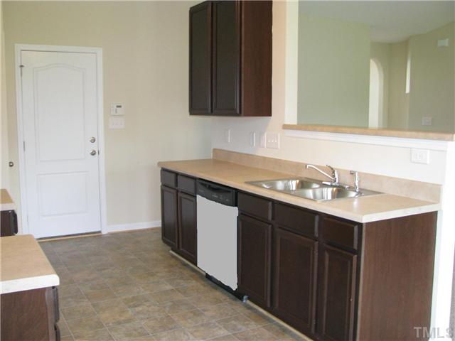 6328 Slopeside Court Raleigh, NC 27610 - Photo 10 of 18 Open Kitchen with Eat-At Bar Overlooking Living Room