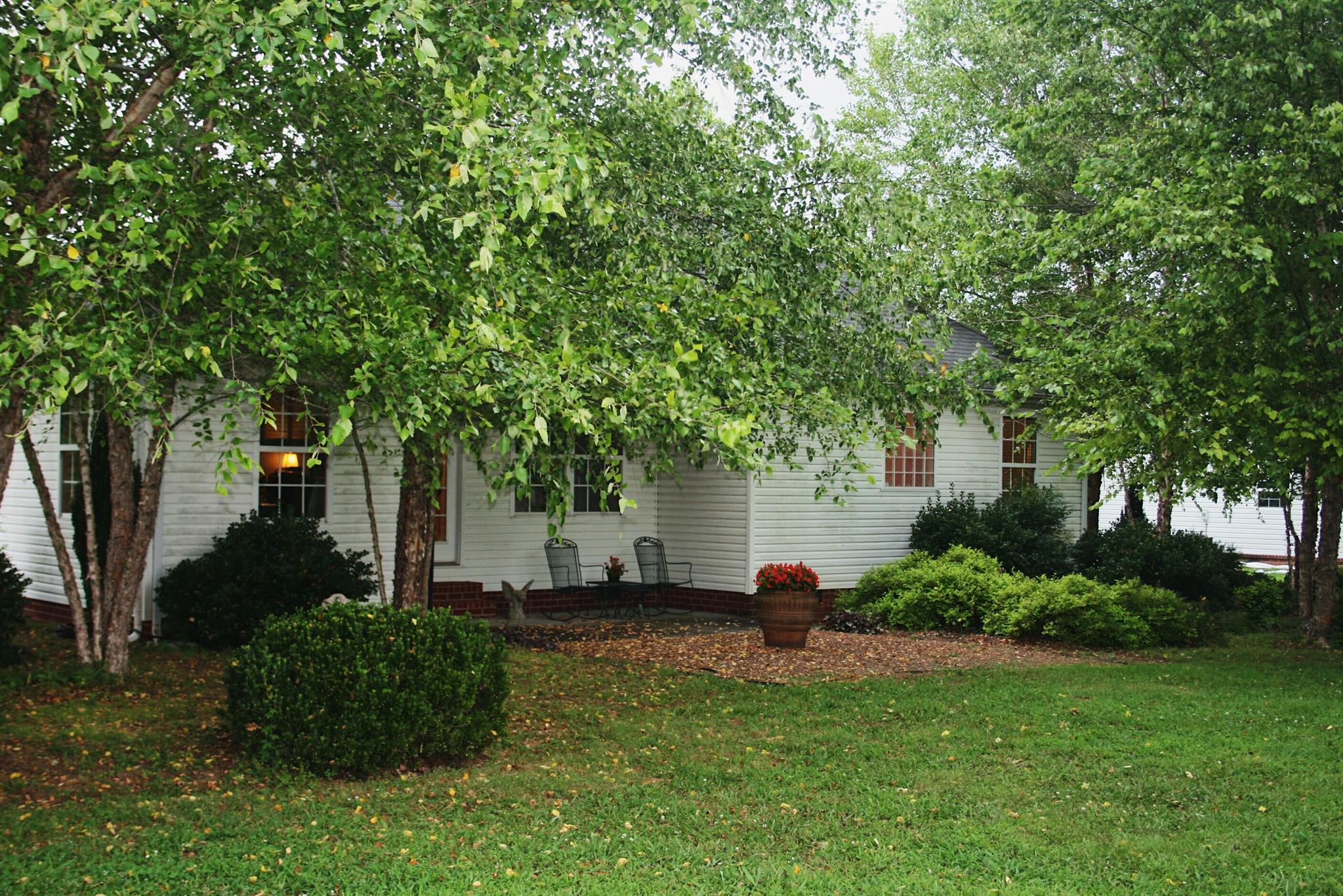 729 Crescent Road Murfreesboro, TN 37128 - Photo 2 of 15 a view of backyard with potted plants and large trees