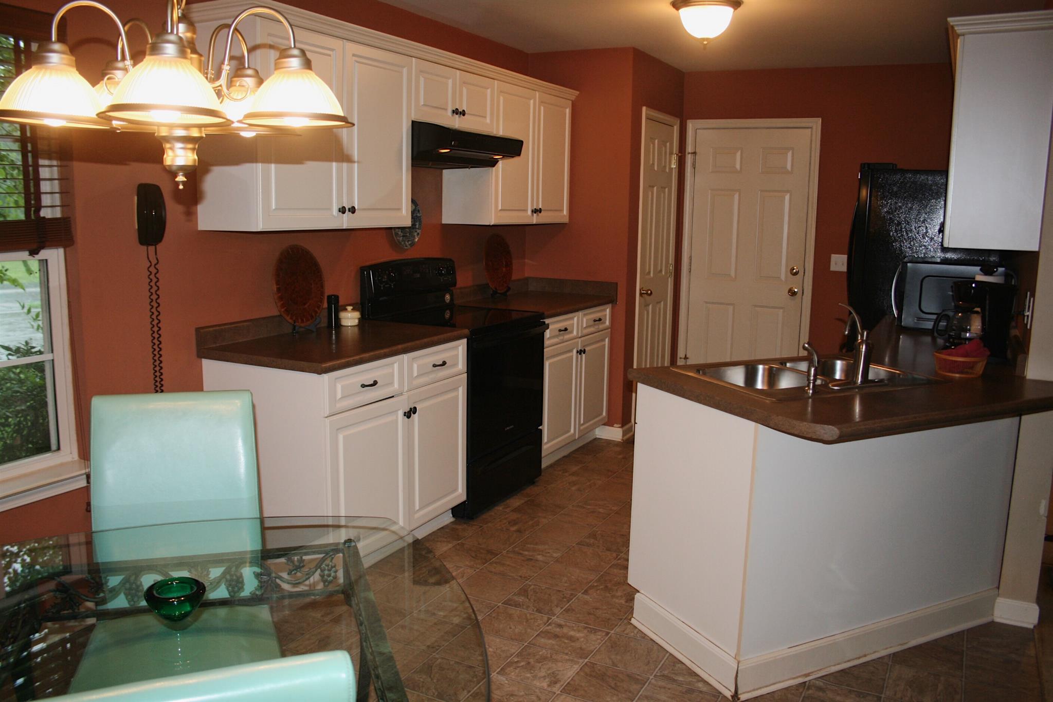729 Crescent Road Murfreesboro, TN 37128 - Photo 7 of 15 a kitchen with granite countertop a sink a stove and a microwave