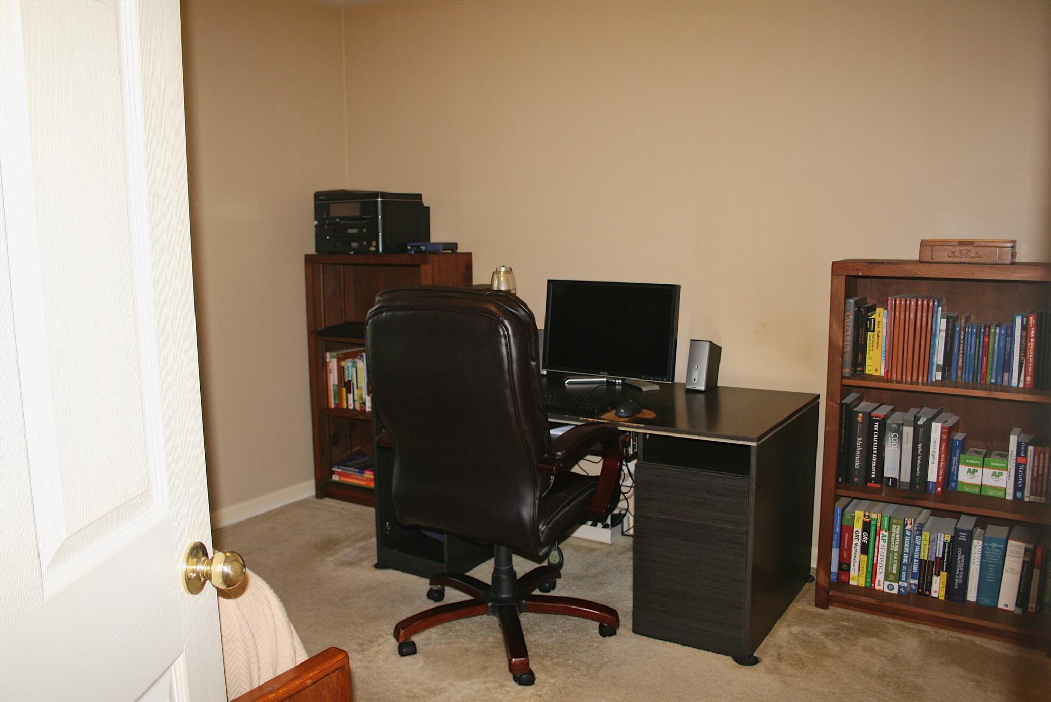 729 Crescent Road Murfreesboro, TN 37128 - Photo 8 of 15 a view of a workspace with furniture and a book shelf