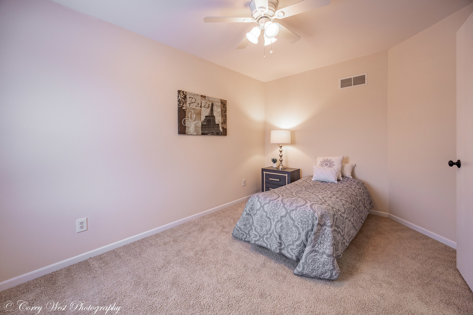 202 Chamberlain Drive DeKalb, IL 60115 - Photo 12 of 28 a bedroom with a bed and a chandelier