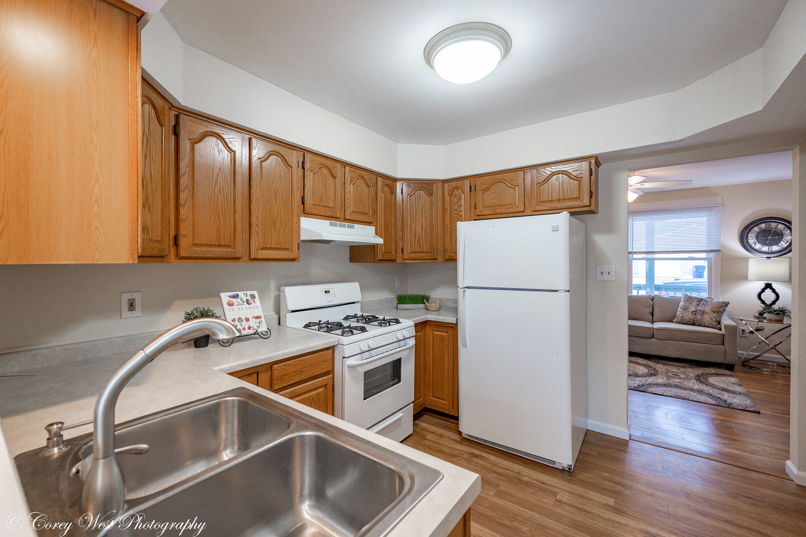 202 Chamberlain Drive DeKalb, IL 60115 - Photo 7 of 28 a kitchen with a refrigerator sink and cabinets