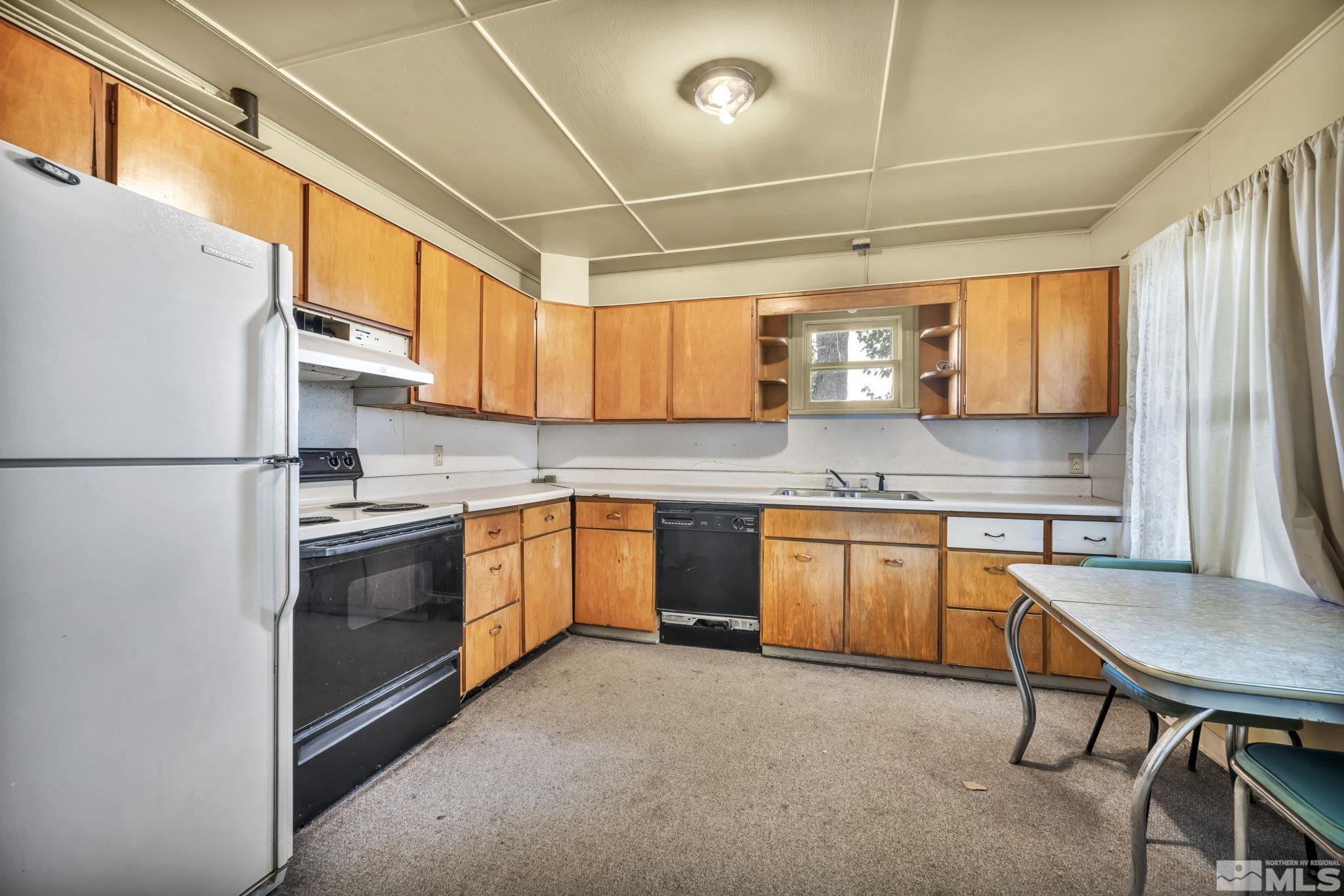 2905 Westfall Road Lovelock, NV 89419 - Photo 9 of 16 a kitchen with stainless steel appliances granite countertop a sink and cabinets
