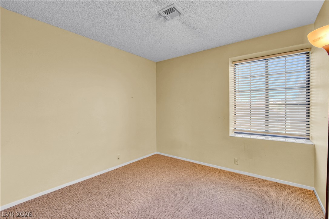 6440 Hartwood Road Las Vegas, NV 89108 - Photo 44 of 59 A quiet, carpeted room with a large window offers a serene personal retreat.