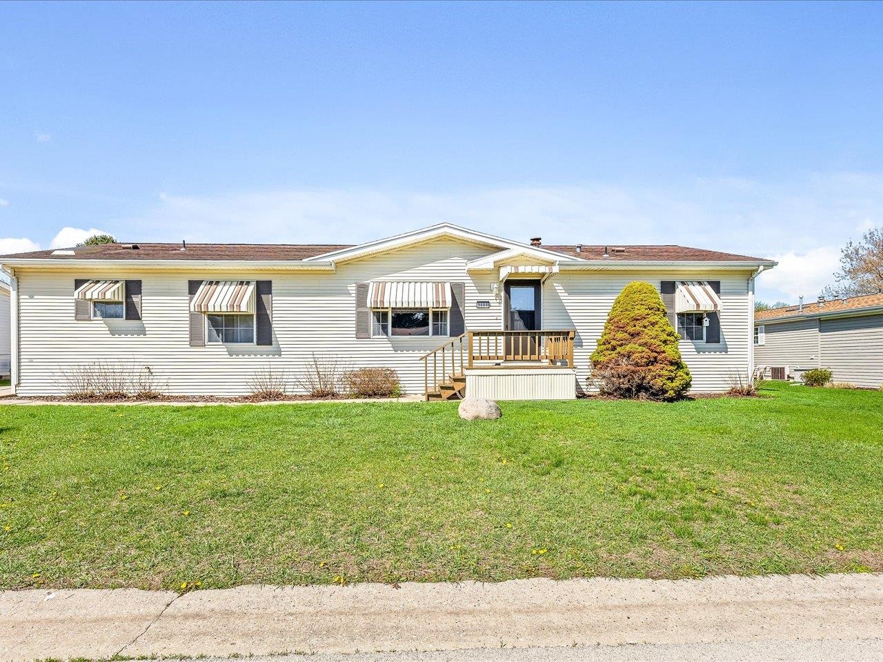 8686 Dutch Elm Court Roscoe, IL 61073 - Photo 1 of 33 a front view of a house with garden