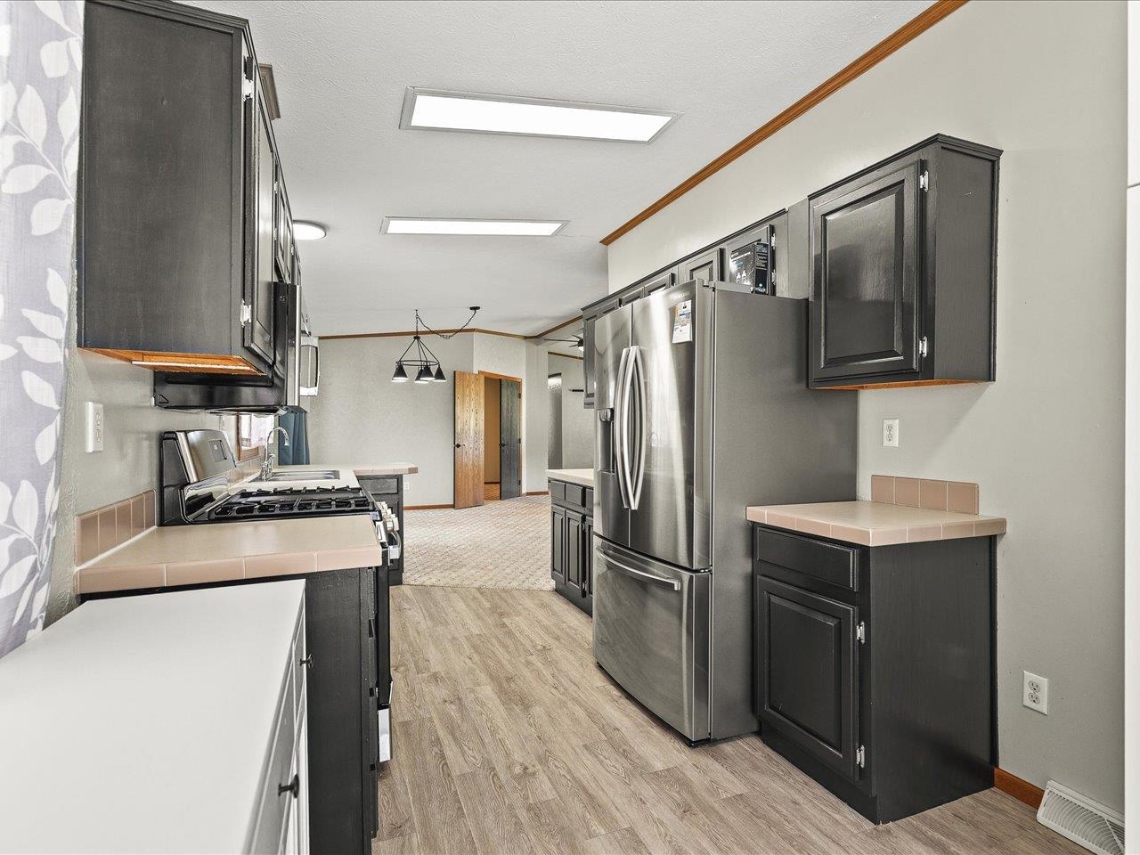 8686 Dutch Elm Court Roscoe, IL 61073 - Photo 16 of 33 a kitchen with cabinets and stainless steel appliances