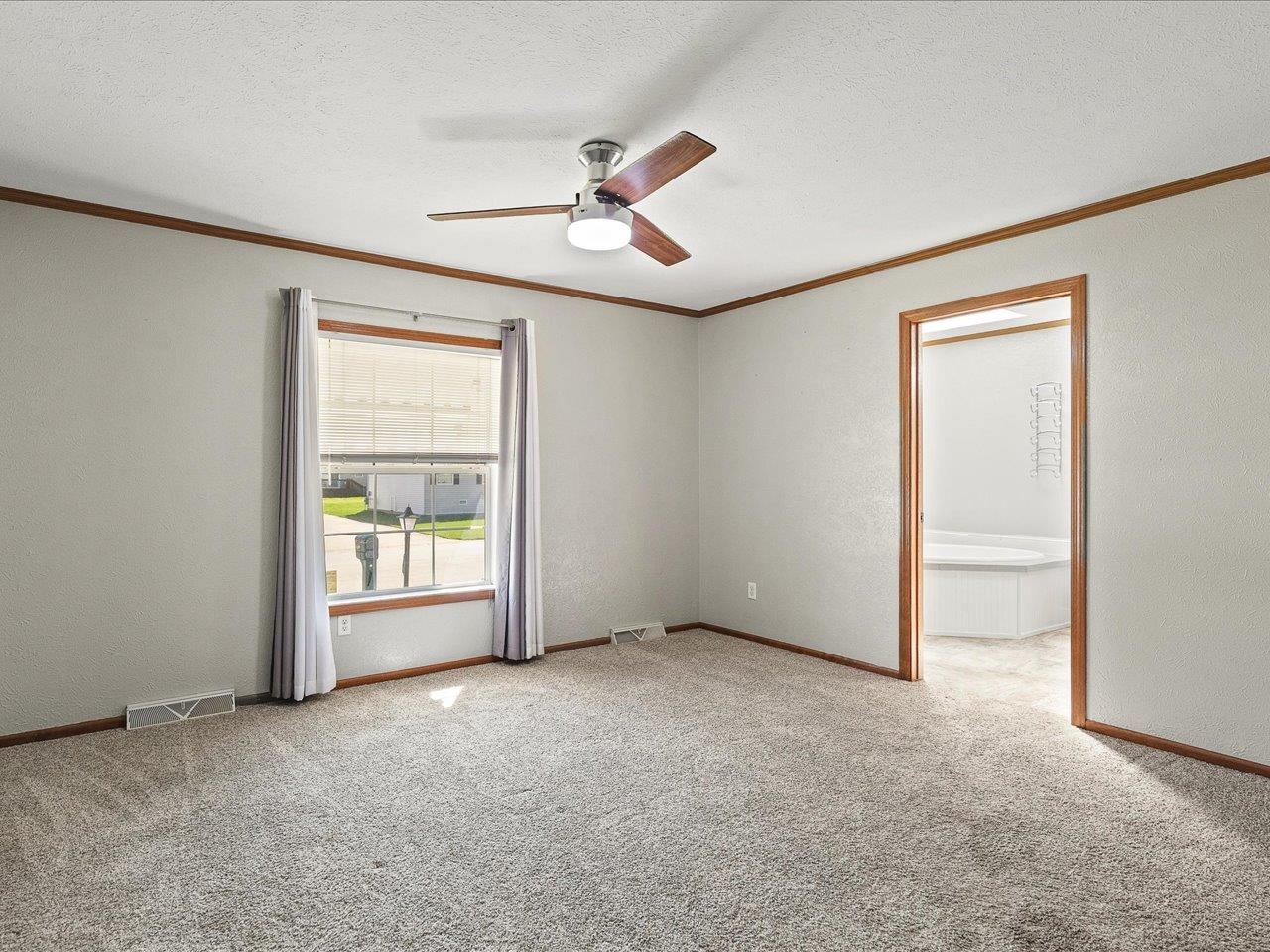 8686 Dutch Elm Court Roscoe, IL 61073 - Photo 18 of 33 an empty room with windows and fan