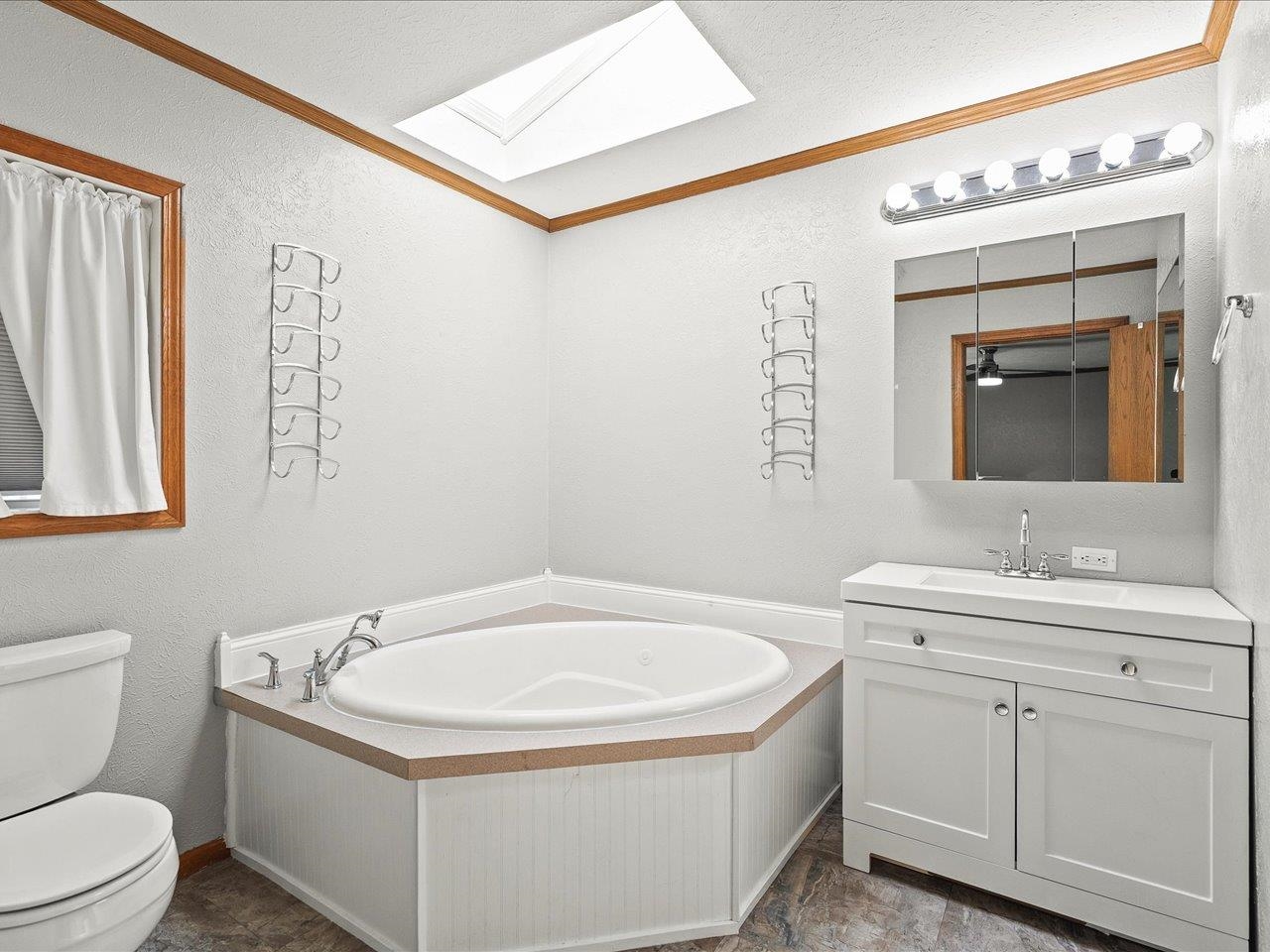 8686 Dutch Elm Court Roscoe, IL 61073 - Photo 21 of 33 a bathroom with a granite countertop sink mirror vanity and toilet