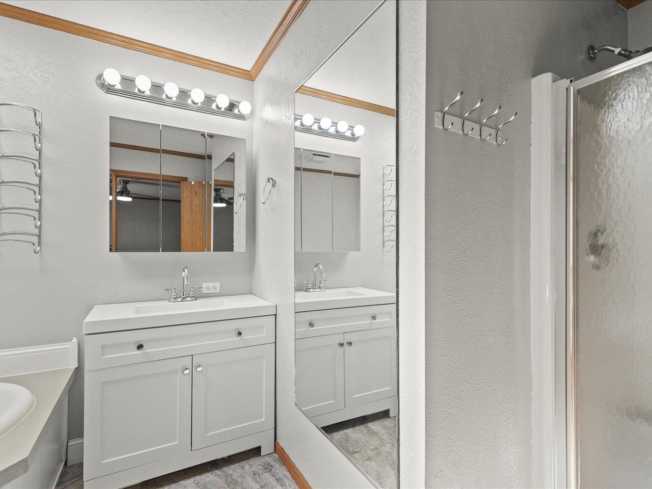 8686 Dutch Elm Court Roscoe, IL 61073 - Photo 22 of 33 a spacious bathroom with a double vanity sink and a mirror