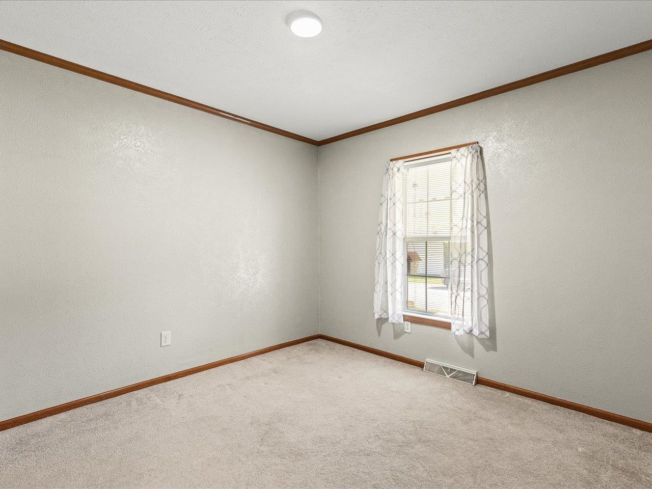 8686 Dutch Elm Court Roscoe, IL 61073 - Photo 26 of 33 an empty room with a window