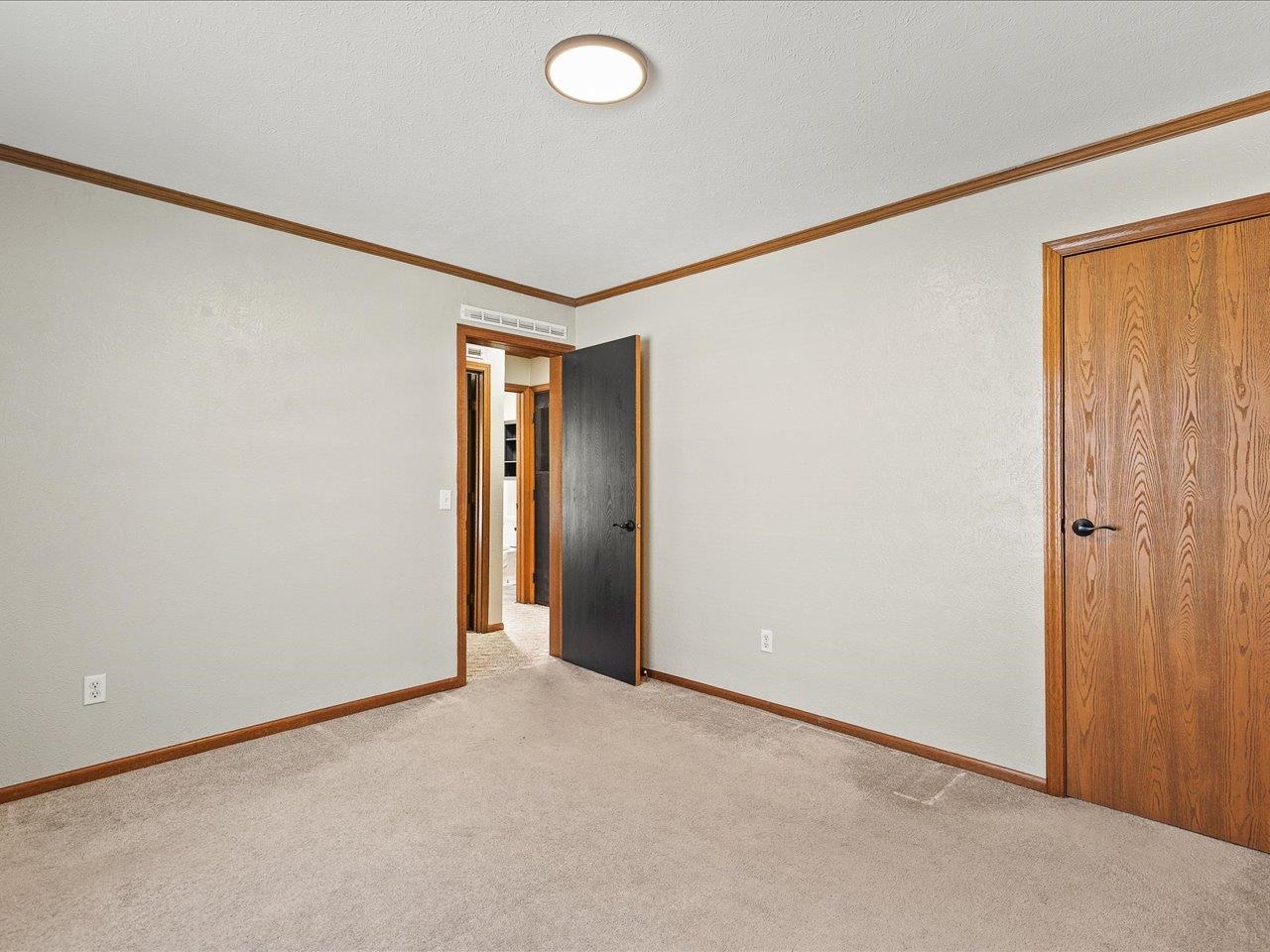 8686 Dutch Elm Court Roscoe, IL 61073 - Photo 29 of 33 an empty room with closet and wooden floor