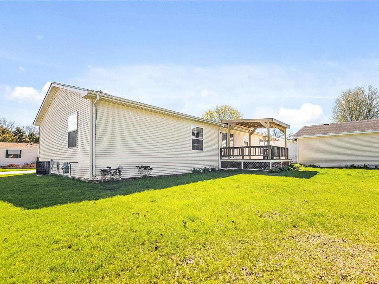 8686 Dutch Elm Court Roscoe, IL 61073 - Photo 31 of 33 a view of swimming pool with lawn chairs and large trees