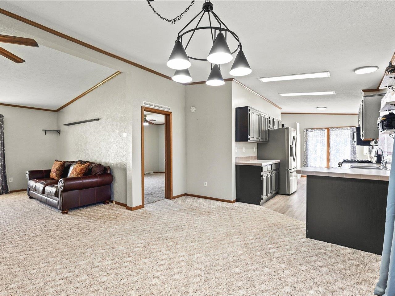 8686 Dutch Elm Court Roscoe, IL 61073 - Photo 10 of 33 a living room with stainless steel appliances kitchen island granite countertop furniture and a kitchen view