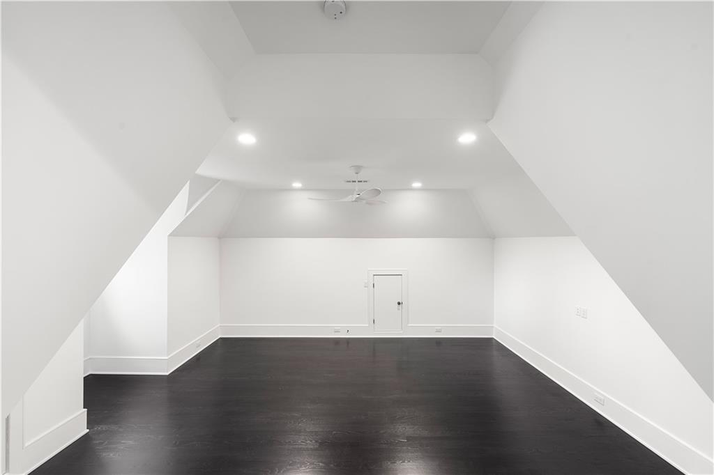 5211 Powers Ferry Road Northwest Sandy Springs, GA 30327 - Photo 96 of 106 an empty room with wooden floor and white walls