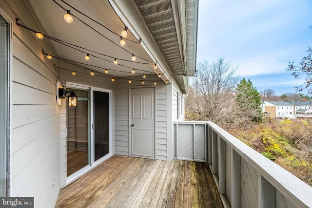 a view of balcony with wooden floor and fence