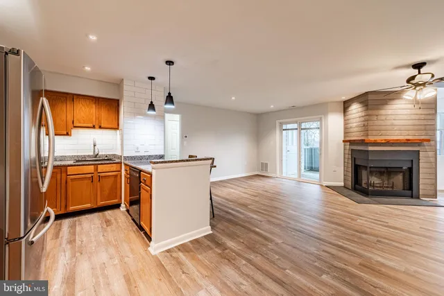 a kitchen with stainless steel appliances granite countertop a stove top oven and sink