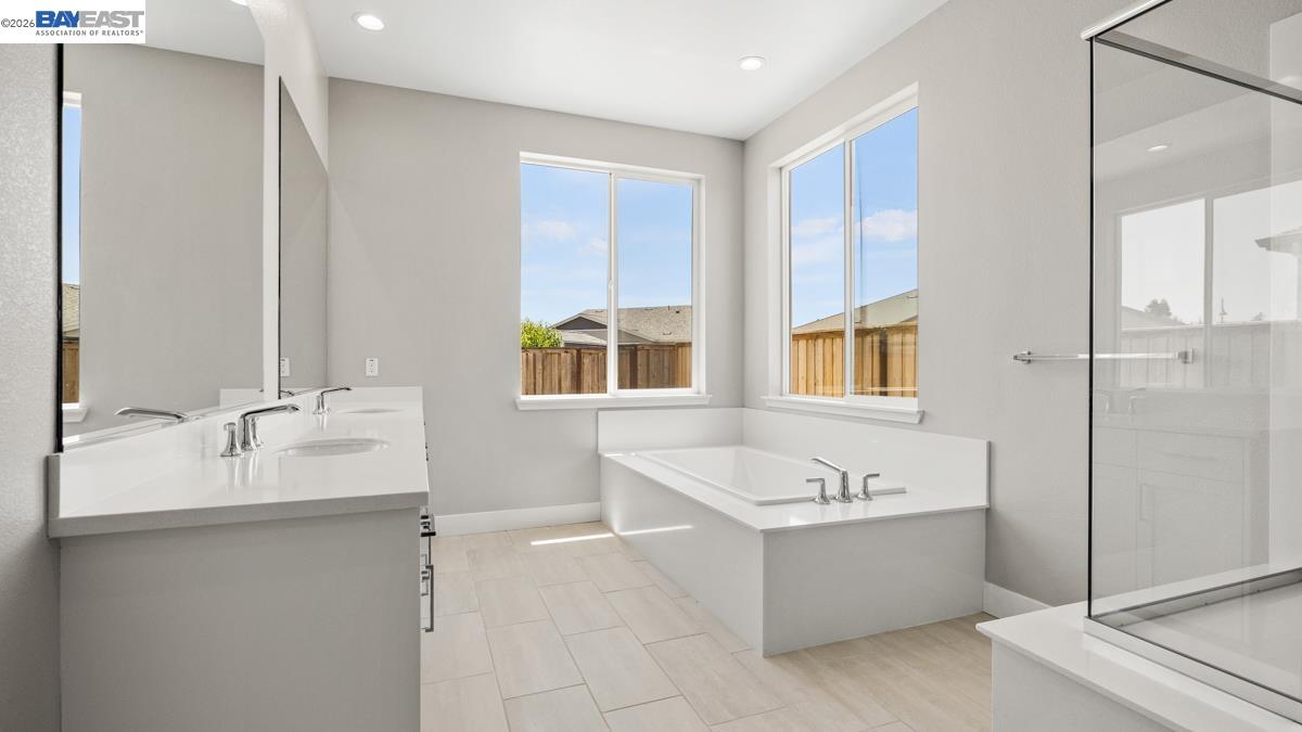 756 Conrad Street Manteca, CA 95336 - Photo 14 of 41 a bathroom with a tub sink shower and mirror