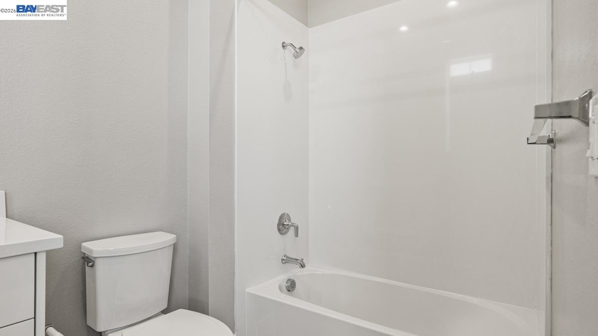 756 Conrad Street Manteca, CA 95336 - Photo 21 of 41 a white toilet sitting next to a bath tub