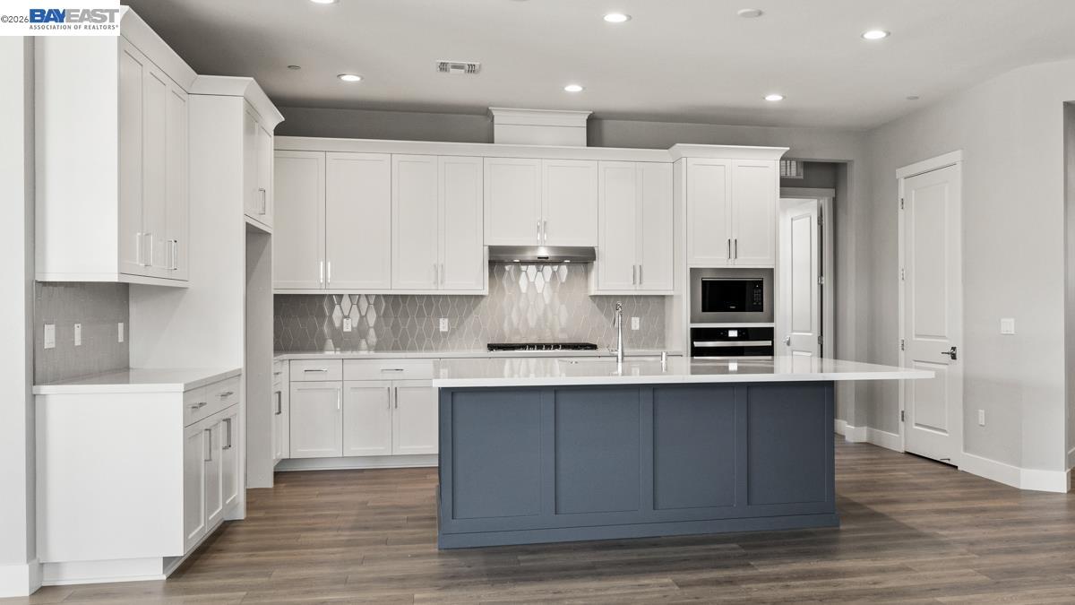 756 Conrad Street Manteca, CA 95336 - Photo 3 of 41 a kitchen with stainless steel appliances sink stove and cabinets