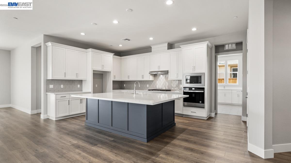 756 Conrad Street Manteca, CA 95336 - Photo 5 of 41 a large kitchen with cabinets and stainless steel appliances