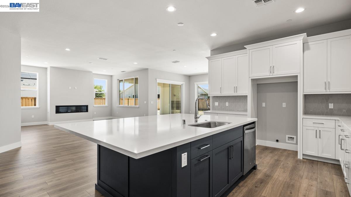 756 Conrad Street Manteca, CA 95336 - Photo 7 of 41 a kitchen with a stove sink and cabinets