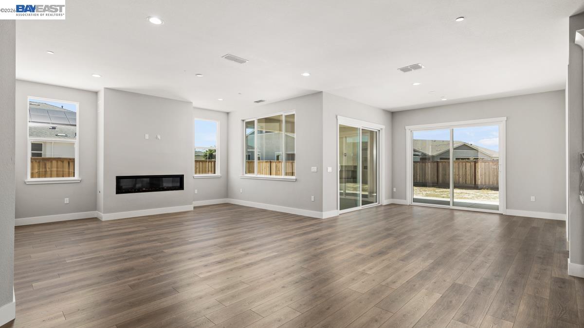 756 Conrad Street Manteca, CA 95336 - Photo 8 of 41 a view of an empty room with wooden floor and a window