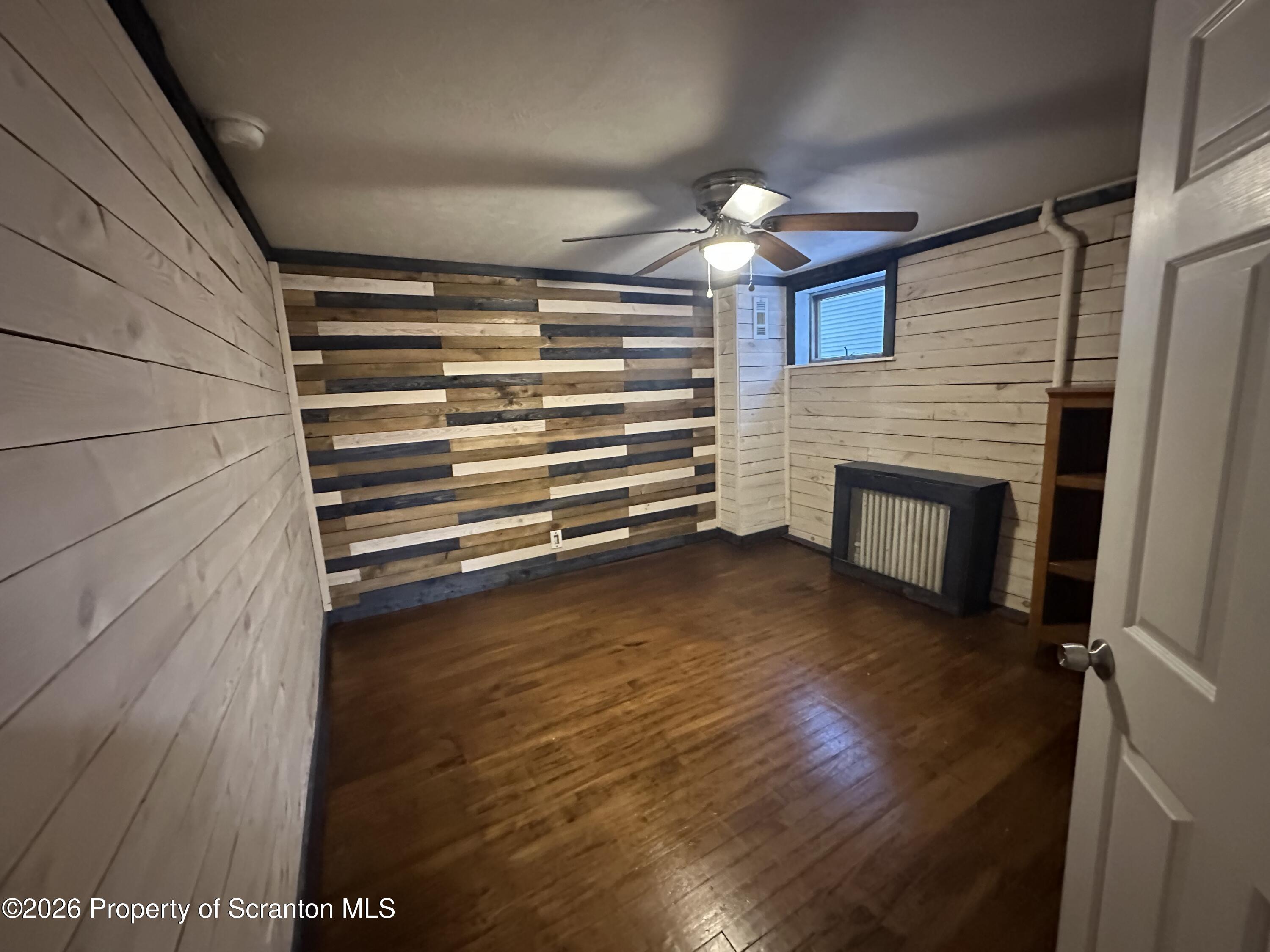 611 Chestnut Street Dunmore, PA 18512 - Photo 11 of 27 a room with a fireplace and wooden floor