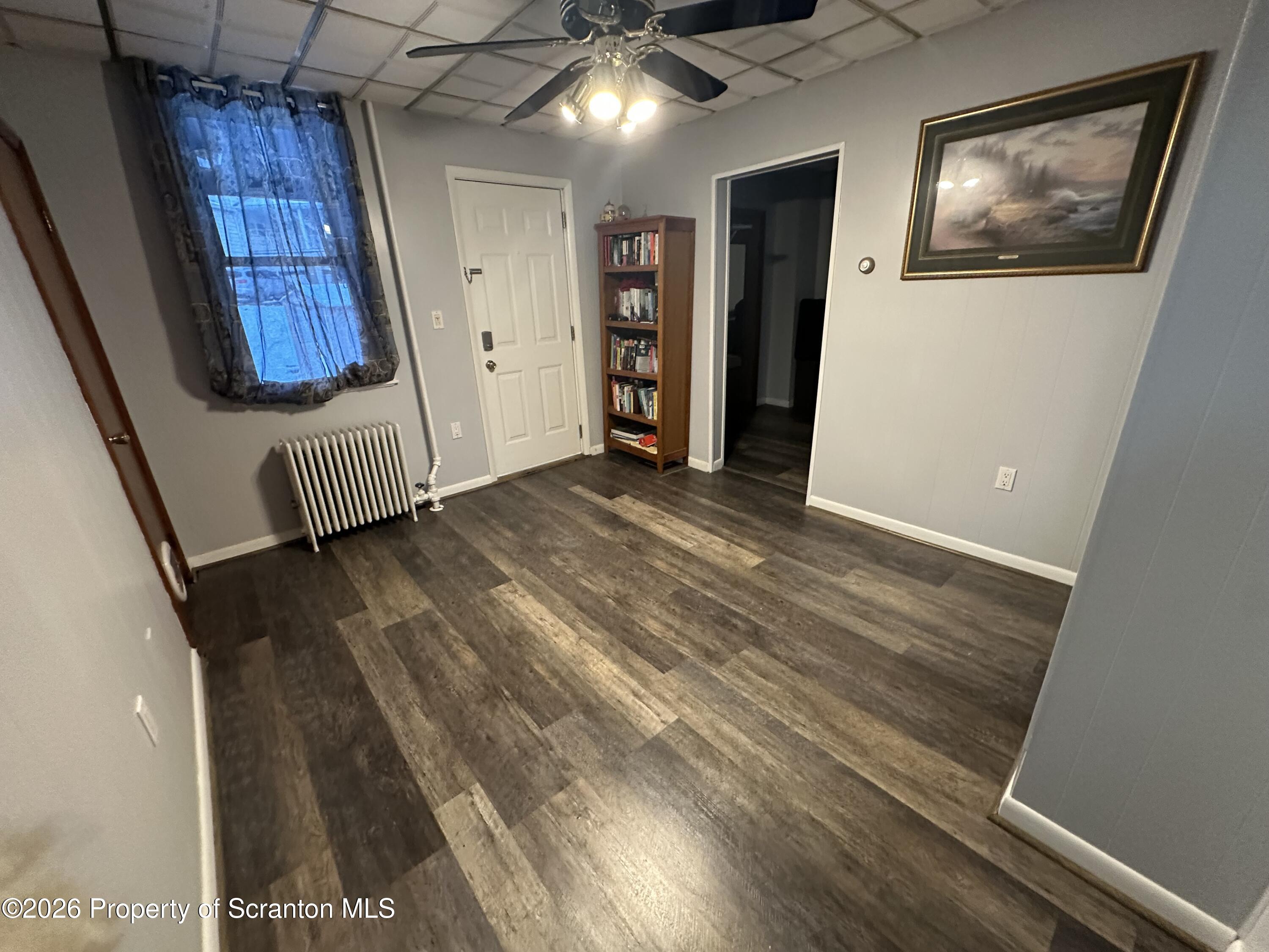 611 Chestnut Street Dunmore, PA 18512 - Photo 18 of 27 a view of an empty room with wooden floor and windows
