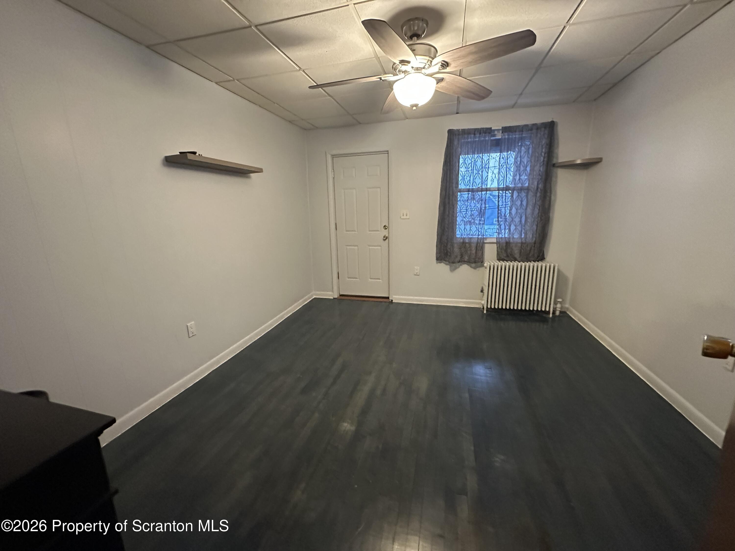611 Chestnut Street Dunmore, PA 18512 - Photo 19 of 27 wooden floor in an empty room with a window