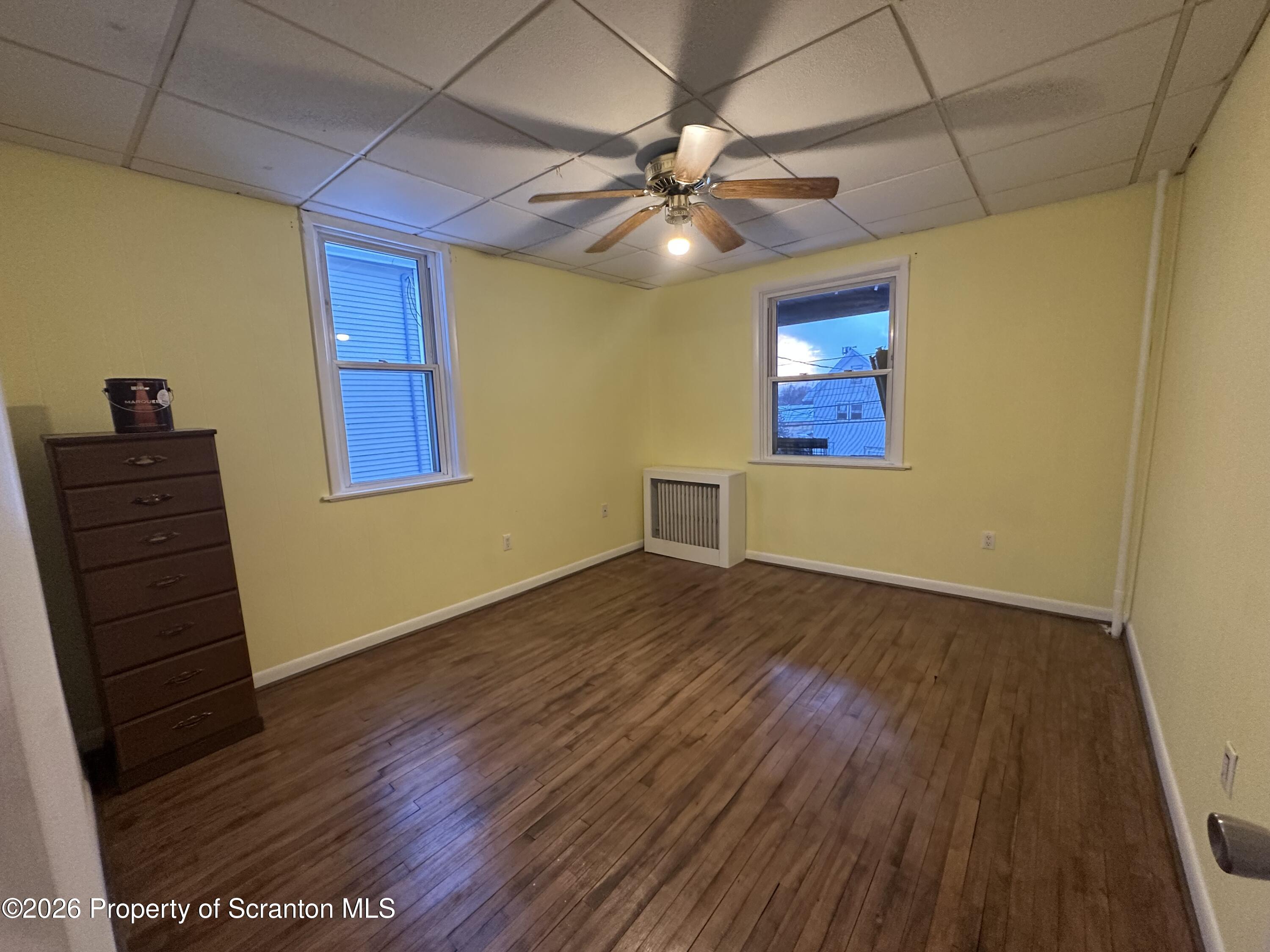 611 Chestnut Street Dunmore, PA 18512 - Photo 20 of 27 a view of an empty room with wooden floor and a ceiling fan