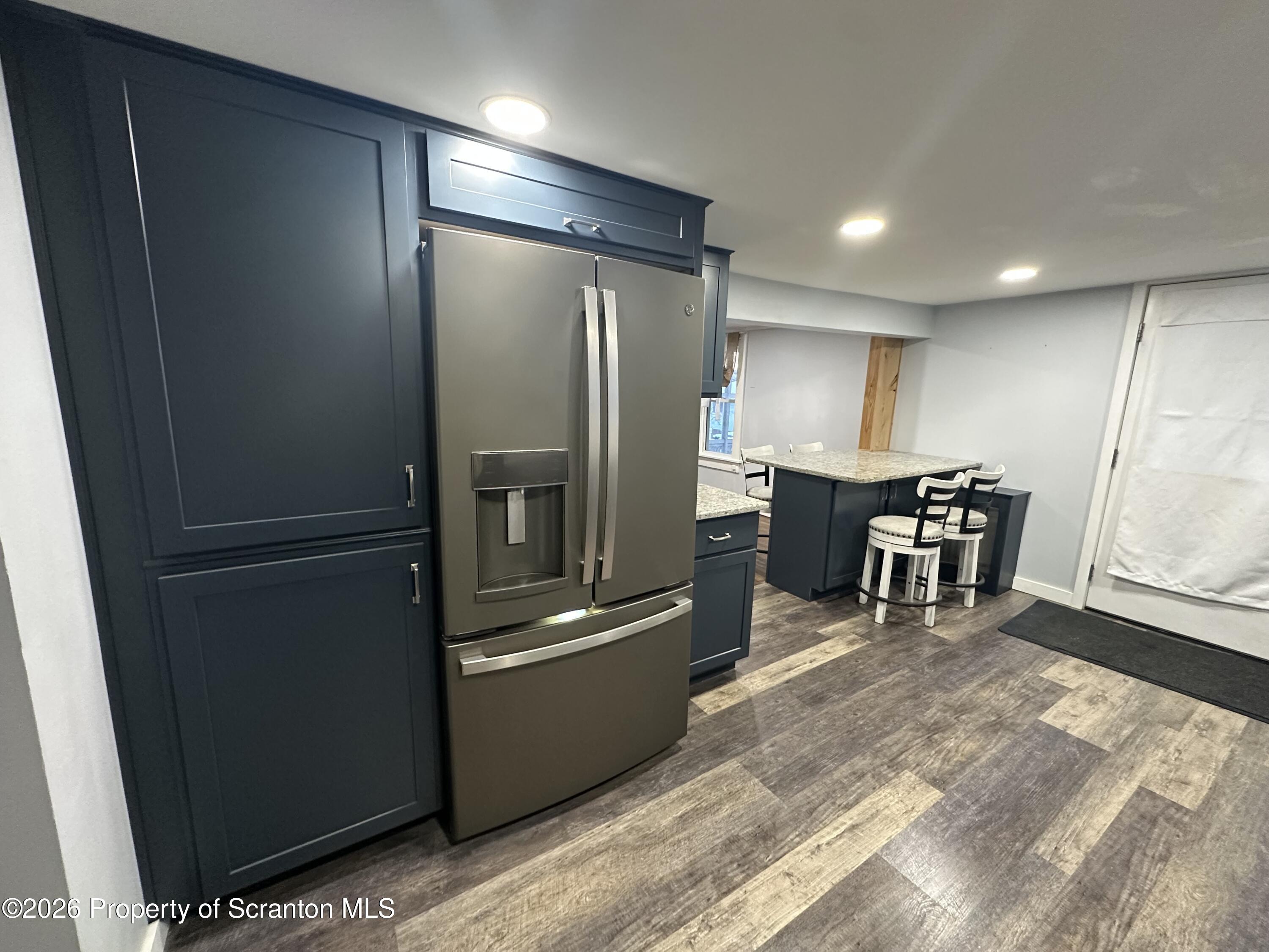 611 Chestnut Street Dunmore, PA 18512 - Photo 2 of 27 a kitchen with a refrigerator and table chair