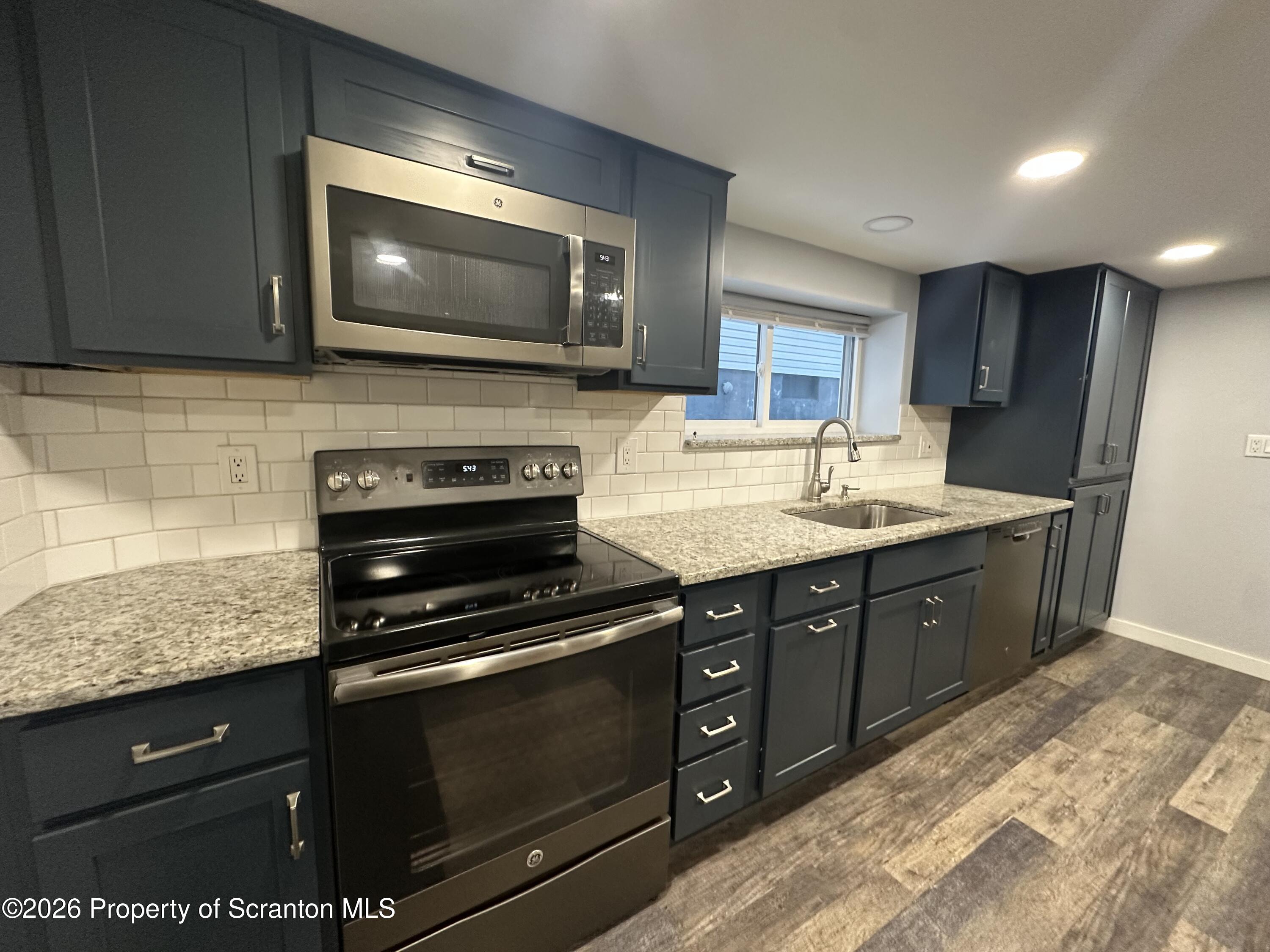 611 Chestnut Street Dunmore, PA 18512 - Photo 5 of 27 a kitchen with a sink stove and microwave