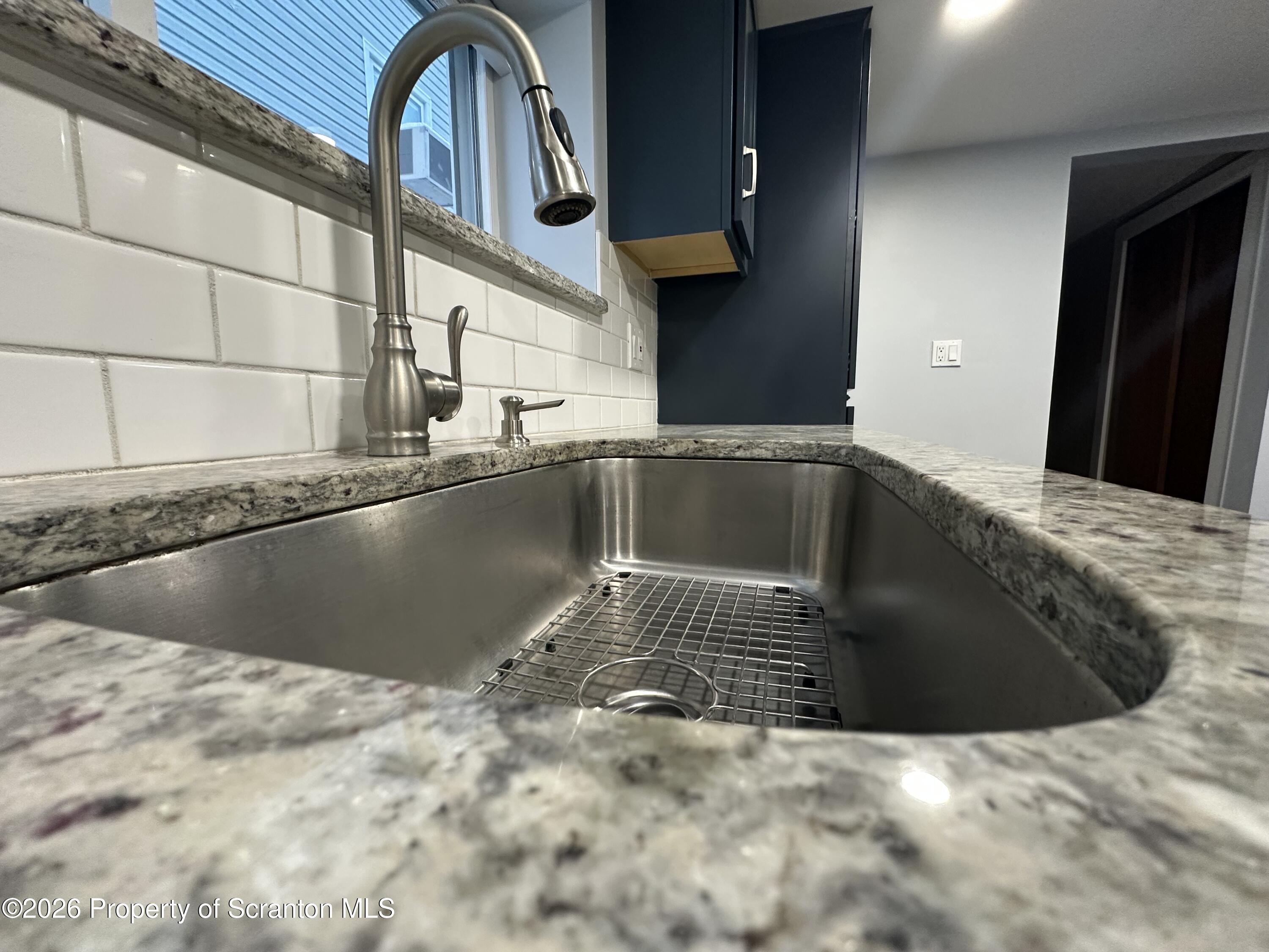 611 Chestnut Street Dunmore, PA 18512 - Photo 8 of 27 a view of a kitchen with a sink and cabinets
